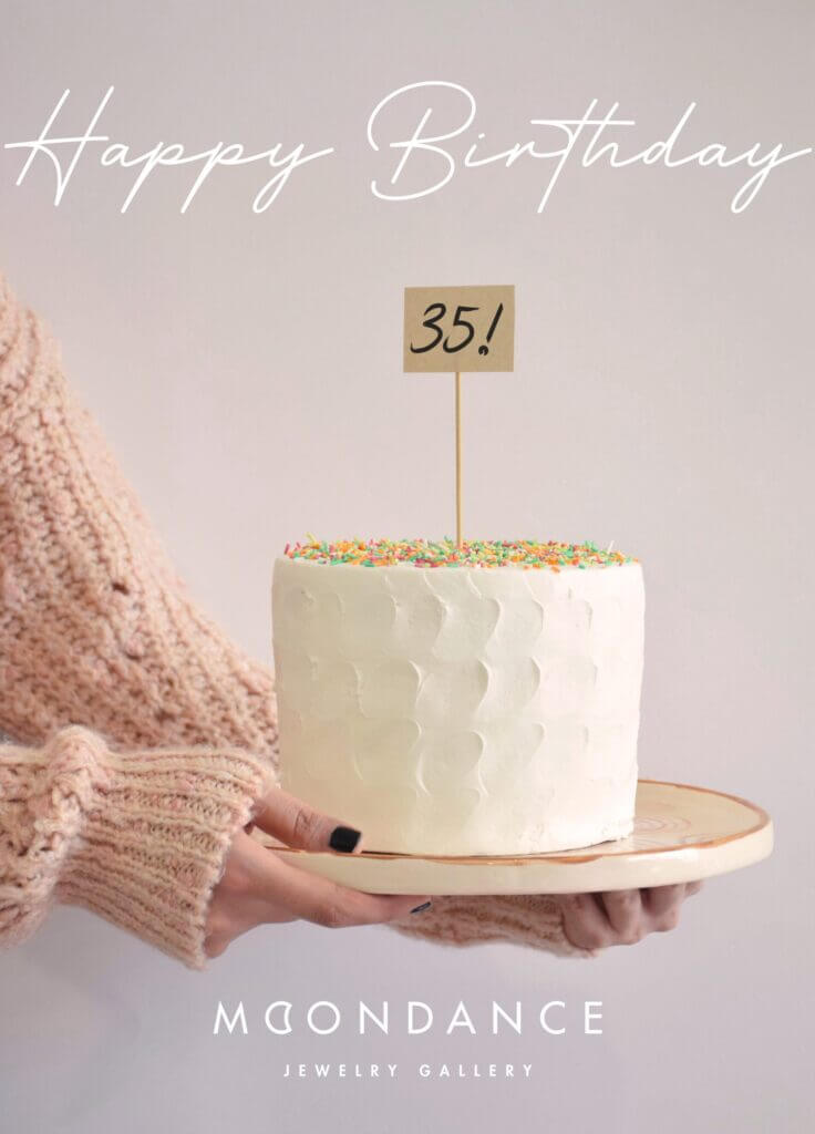 Hands holding a birthday cake. Text saying Happy Birthday 35! Moondance Jewelry Gallery